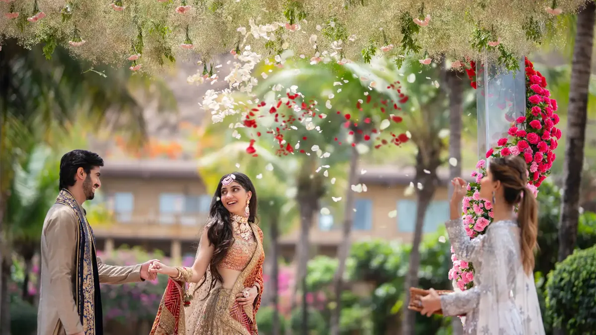 Wedding couple under a floral mandap at Della Resorts